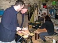 Stephen and Loughie work on the gouging of the hull. Photo: Douglas Cecil